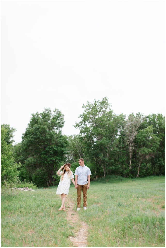Couple standing in a field in Provo Canyon. Utah couples photo shoot. Photo by Utah Photographer Mary Horne Nelson.