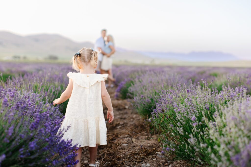 Family at the lavender fields in Utah, daughter looking at parents.