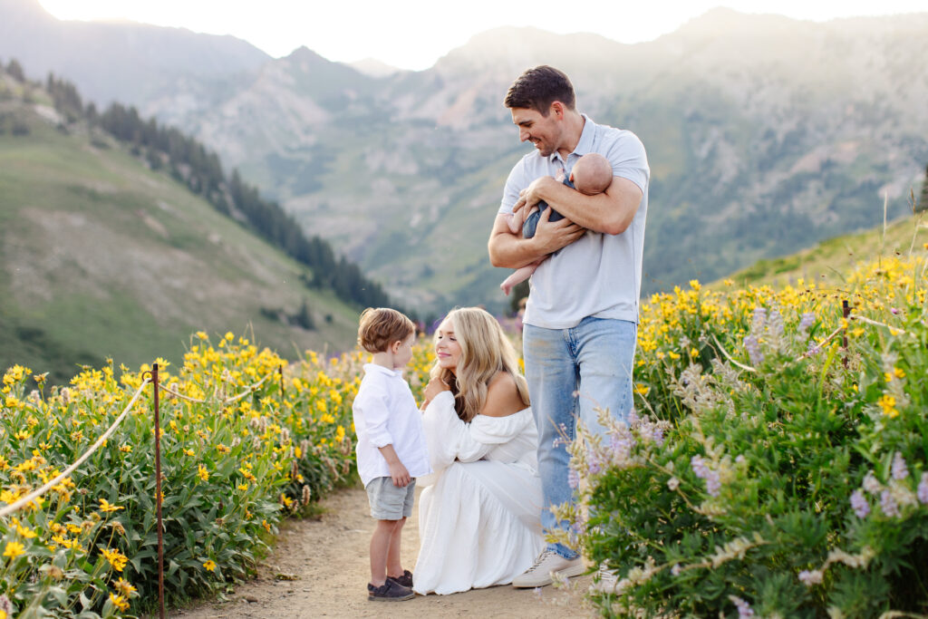 Family playing together in a field of wildflowers in Utah. Taken by Utah Family Photographer Mary Horne Nelson.