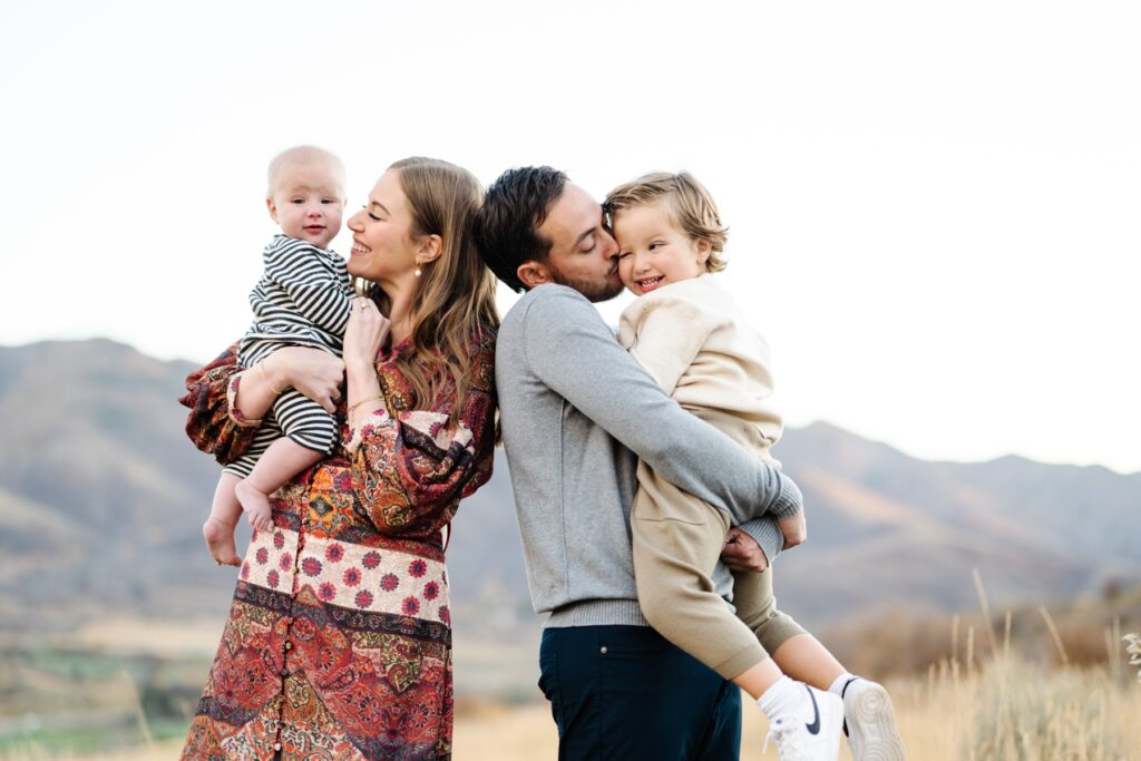 Family playing together in their fall family picture. Photo taken in Salt Lake City. 