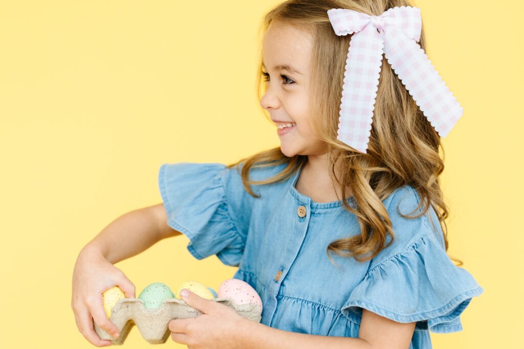 Commercial Photography for Children's brands in Utah. Easter campaign photo shoot with girl holding a carton of pastel-colored eggs.