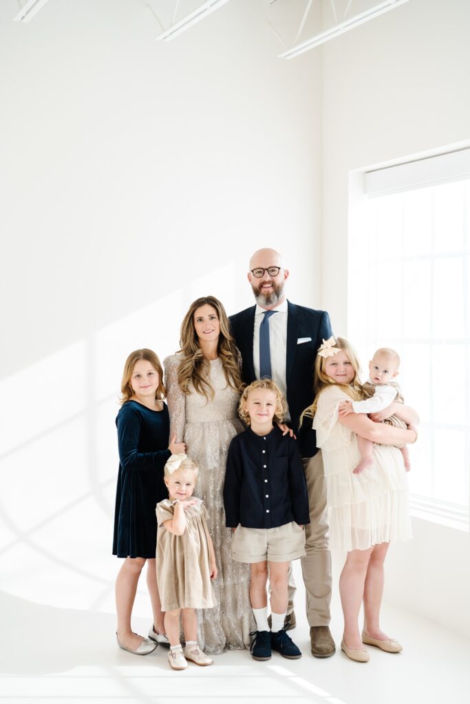 Family poses together in a portrait, studio family pictures in Utah 