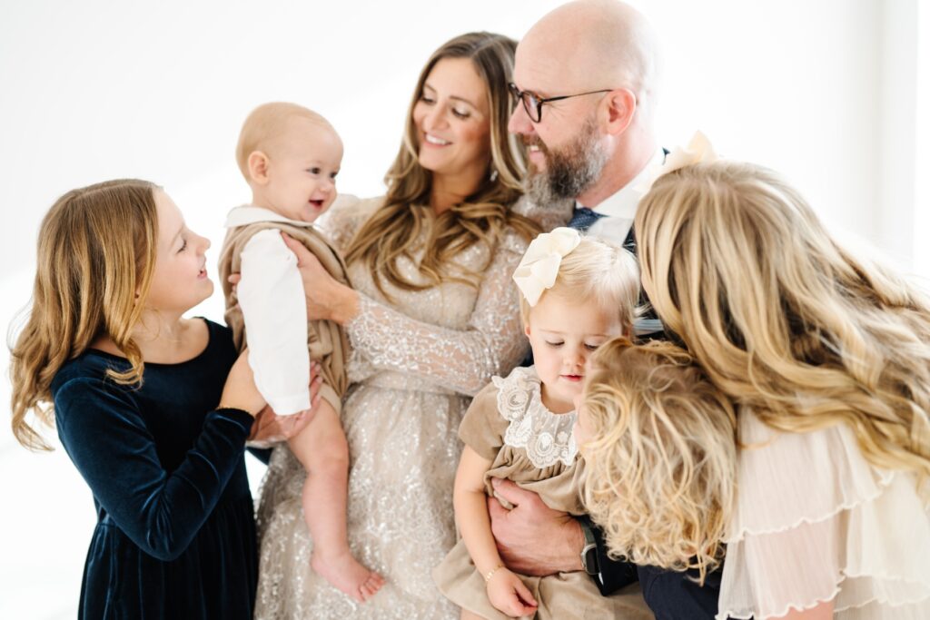 Family snuggles in a white studio